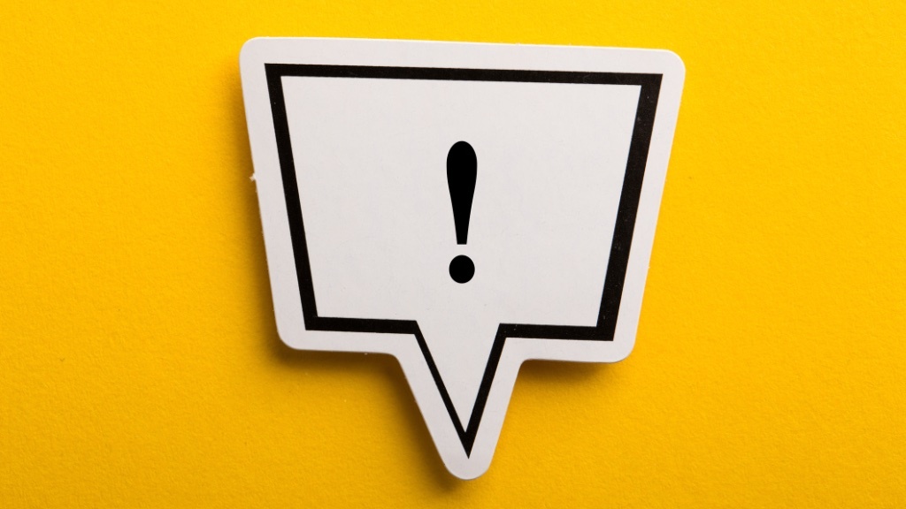A white speech bubble with a bold black exclamation mark inside is set against a bright yellow background, signaling importance or urgency.