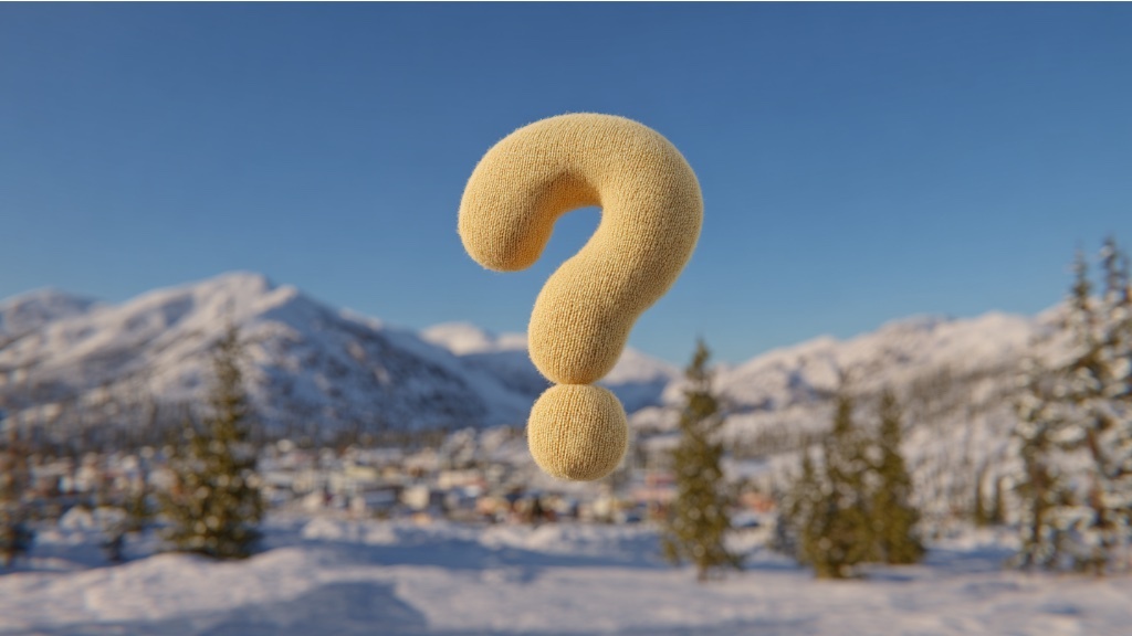 Ett mjukt, stickat frågetecken svävar i luften framför ett snötäckt vinterlandskap med berg och träd i bakgrunden.