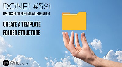 A hand is holding up a yellow folder icon against a blue sky with fluffy clouds.
