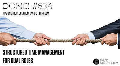 Two people in business attire are engaged in a tug-of-war, each pulling on opposite ends of a rope.