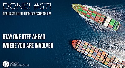 Two large container ships travel across the open sea leaving white wakes behind them.