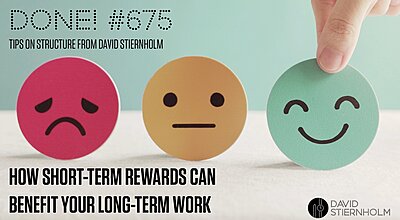 A hand is selecting a green smiling emoji disc from a row of three paper emoji faces representing unhappy, neutral, and happy emotions.