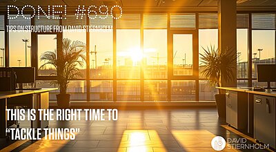 A sunlit office space features large floor-to-ceiling windows with a golden sunset view, two potted tropical plants, and dark tiled flooring casting long shadows.