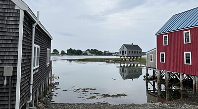 Sea view of three houses on stilts in Cape Porpoise, Maine