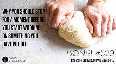 Two hands kneading a sour-dough on a marble table.