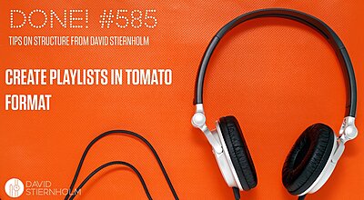 Headphones with black and white accents are laid out on an orange textured background.